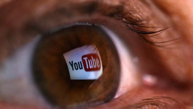 A picture shows the logo of YouTube reflected in the eye of a person in the town of Zenica, Bosnia. (Photo: Reuters)