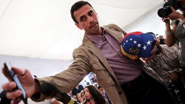 Venezuelan opposition leader Henrique Capriles gestures as he arrives for a news conference in Caracas, Venezuela.