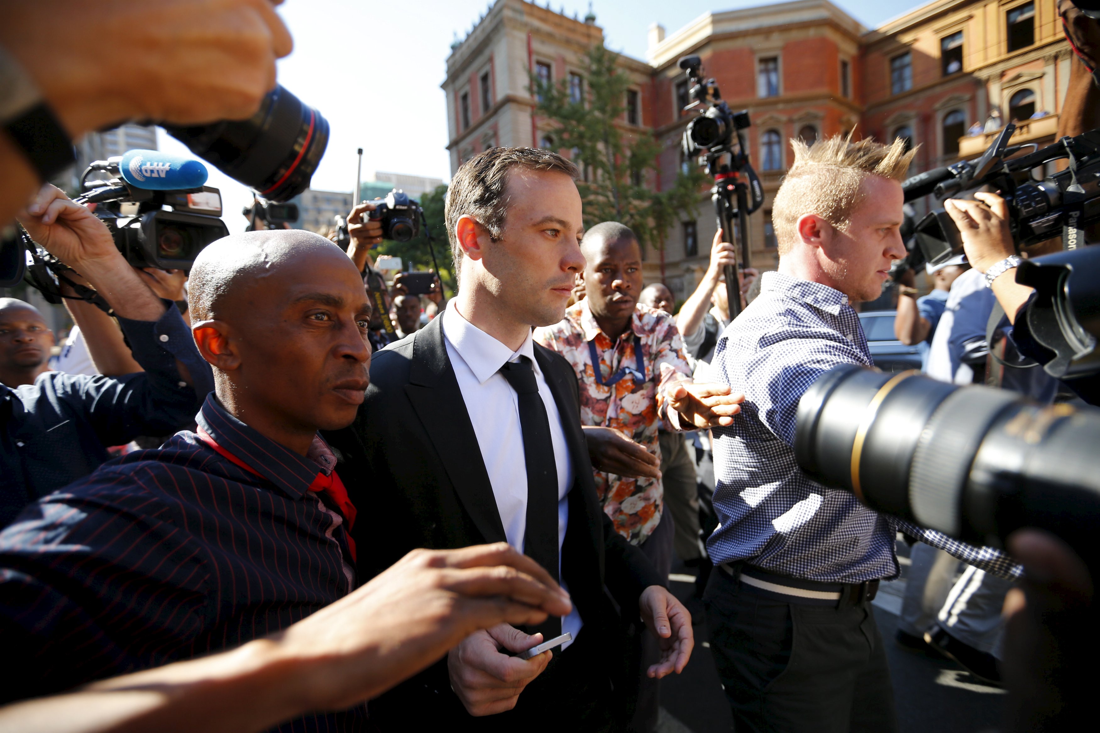South African Olympic and Paralympic sprinter Oscar Pistorius (C) leaves the North Gauteng High Court in Pretoria after a brief appearance, April 18, 2016.