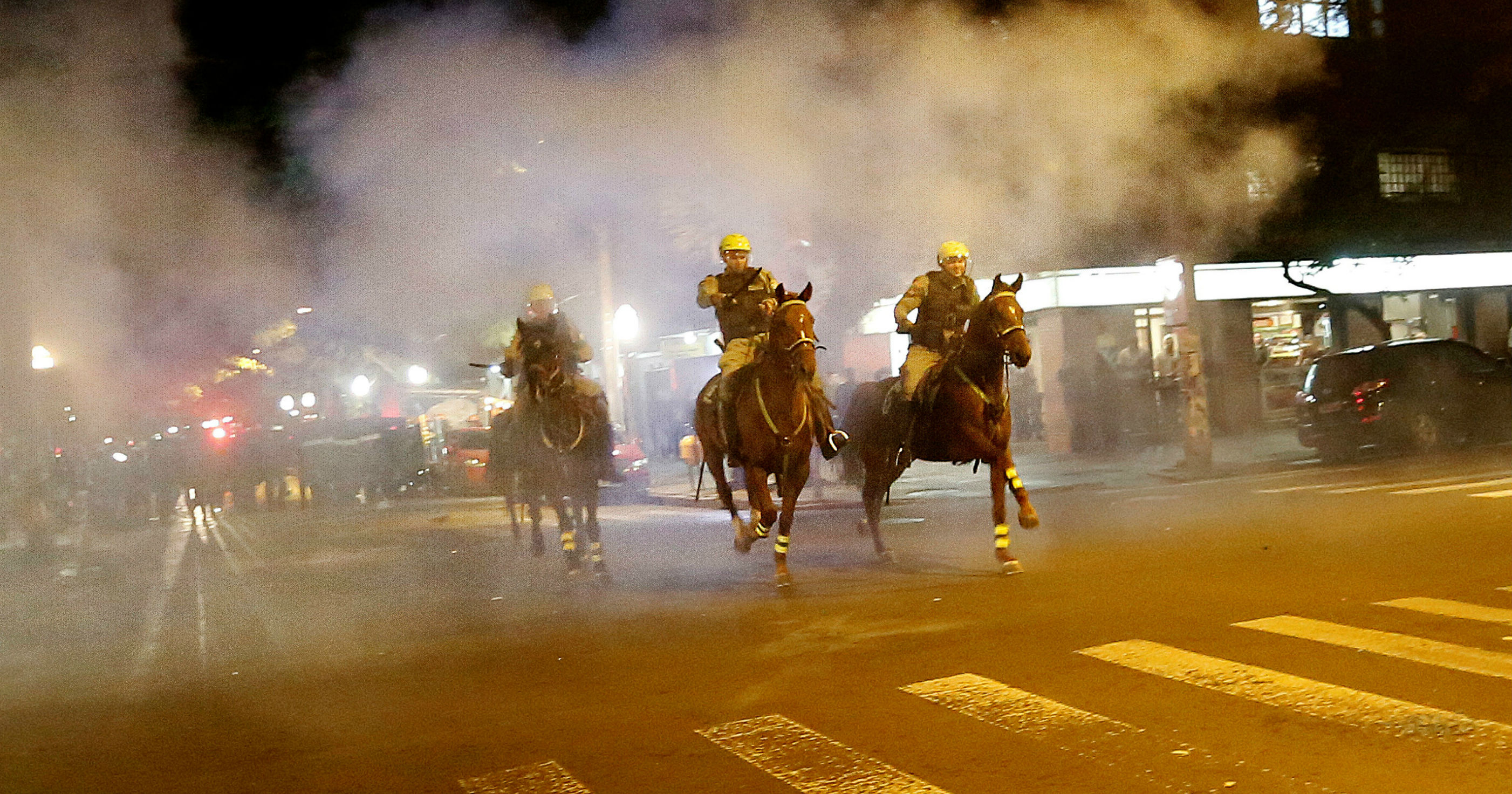 Policemen ride their horses during a clash with demonstrators at a protest against the impeachment of President Rousseff in Porto Alegre
