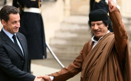 France's President Nicolas Sarkozy (L) greets Libyan leader Moammar Gadhafi in the courtyard of the Elysee Palace in Paris on Dec. 10, 2007.