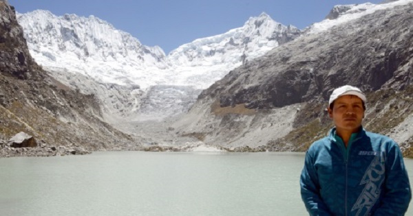 Peruvian mountain guide Saul Luciano Lliuya, stands in front of a lagoon that has formed at the base of the almost disappeared Churup Glassier in Ancash, Peru.