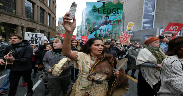 St'at'imc bear dancer Jackie Andrew burns sage during a protest against the Kinder Morgan Trans Mountain Pipeline in Vancouver, Canada.