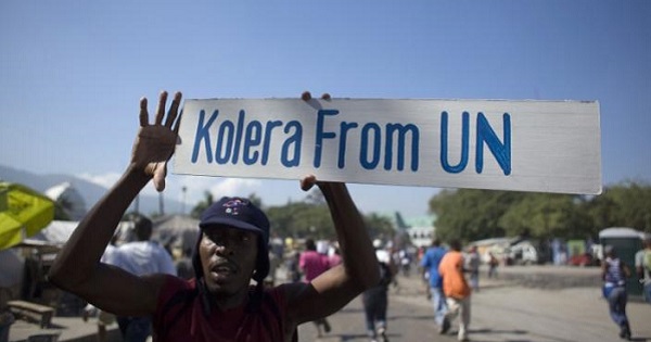 A protester holds up a sign during a demonstration against the U.N. mission in downtown Port-au-Prince, Nov. 18, 2010.