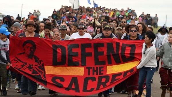 Native Americans march to a sacred burial ground site they say was disturbed by bulldozers building the Dakota Access Pipeline