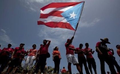A protester waves a Puerto Rican independence flag during a protest in San Juan.