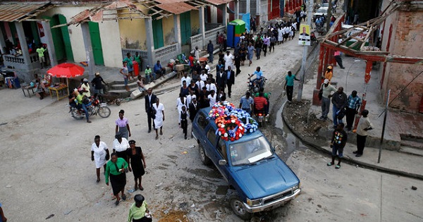 Relatives walk behind the hearse during the funeral of a woman who died during Hurricane Matthew in Jeremie, Haiti, Oct. 18, 2016.