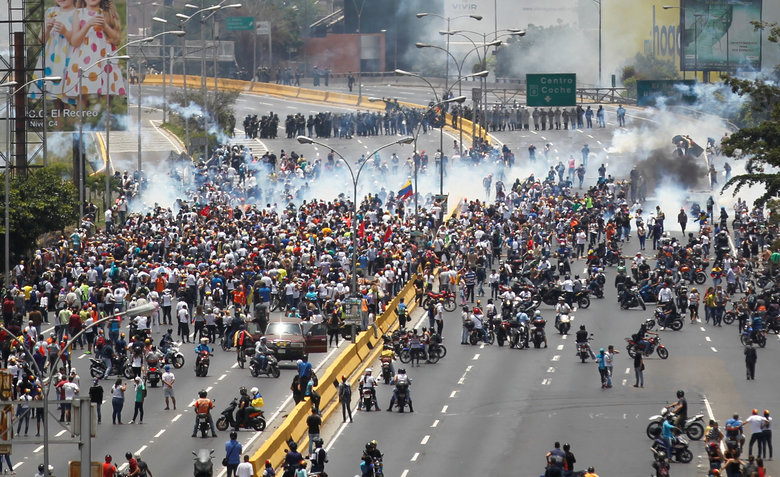Anti-government protesters clash with riot police in Caracas.