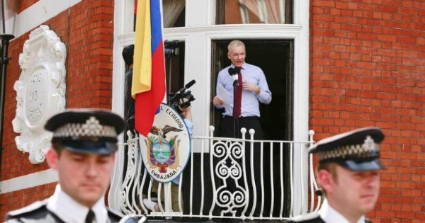WikiLeaks founder Julian Assange stands outside of the Ecuadorean embassy in London.