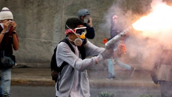 A protester is seen firing a homemade mortar at police during a clash in Caracas of the variety suspected of causing Cañizales's death.