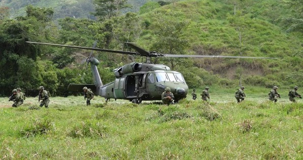 Soldiers of the Colombian Army disembark from a helicopter in a zone previously occupied by FARC rebels, Saiza, Colombia, Feb. 3, 2017.