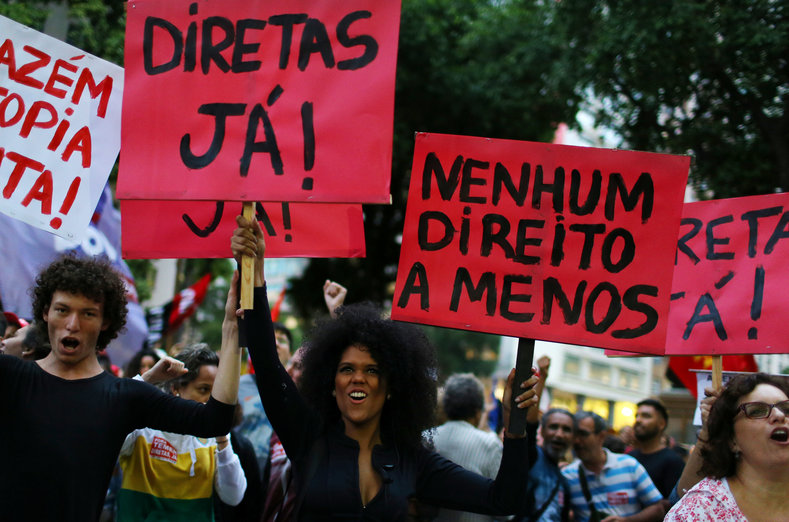Demonstrators attend a protest against Brazil's President Michel Temer in Rio de Janeiro, Brazil, May 18, 2017. The signs read: 