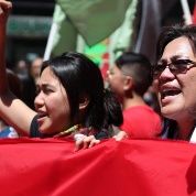 Aurora Victoria David (center, raised fist) marches with her mother (right) in San Francisco, California, on International Worker's Day, May 1, 2017.