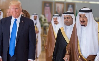 Saudi Arabia's King Salman bin Abdulaziz Al Saud walks with U.S. President Donald Trump during a reception ceremony in Riyadh, Saudi Arabia, on May 20, 2017.