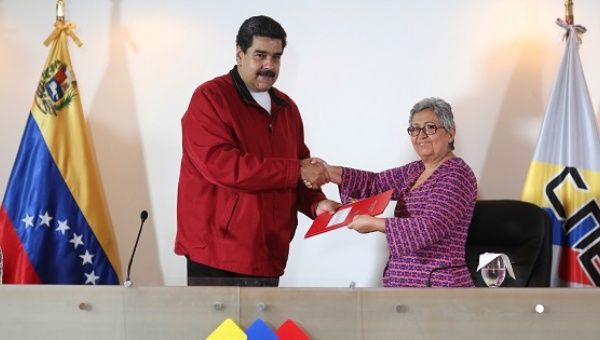 Venezuela's President Nicolas Maduro stands next to Venezuela's National Electoral Council President Tibisay Lucena during a meeting in Caracas.