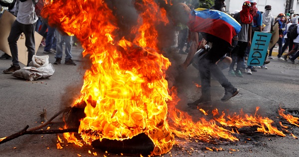 Opposition supporters set up a burning barricade at a rally against Venezuela's President Nicolas Maduro in Caracas, May 20, 2017.