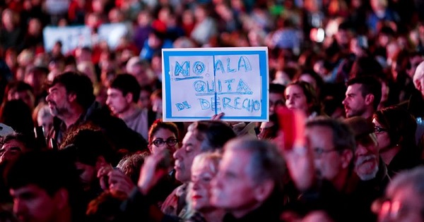 Hundreds of people gathered in Buenos Aires to protest cuts to disability pensions. Sign reads, 