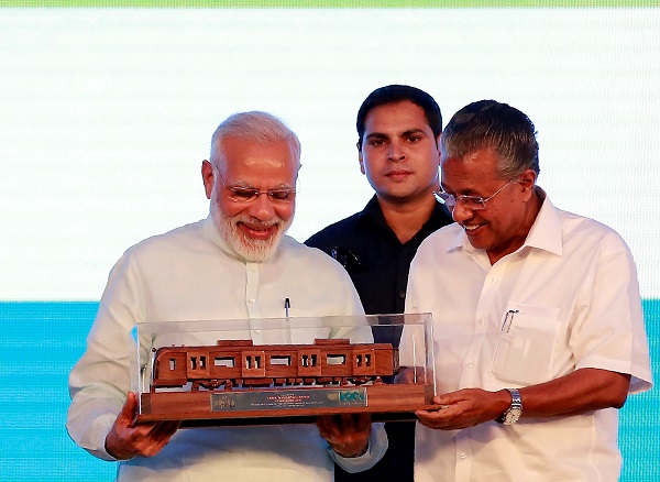 India's Prime Minister Narendra Modi (L) receives a model of Kochi Metro after he inaugurated the transport system in Kochi, India, June 17, 2017