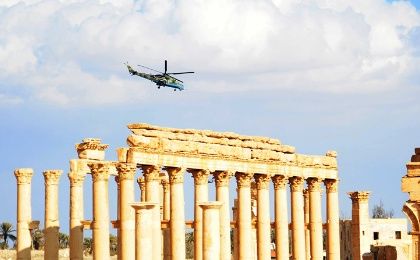 A Russian helicopter hovers over the ancient city of Palmyra, central Syria, on March 4, 2017.