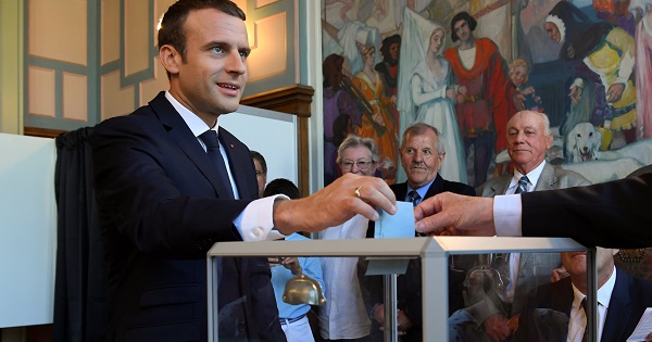 French President Emmanuel Macron casts his ballot as he votes at a polling station in the second round parliamentary elections in Le Touquet.