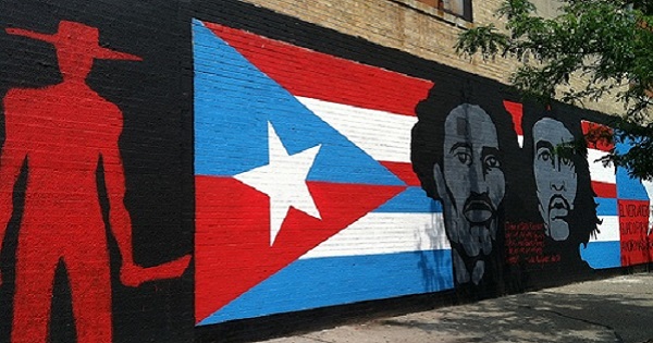 Che Guevara and Don Pedro Albizu Campos are shown along with the Cuban and Puerto Rican flags in this Spanish Harlem mural titled, 