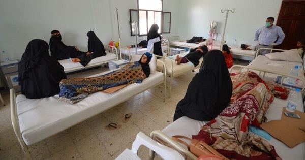 Women sit with relatives infected with cholera at a hospital in the Red Sea port city of Hodeidah, Yemen