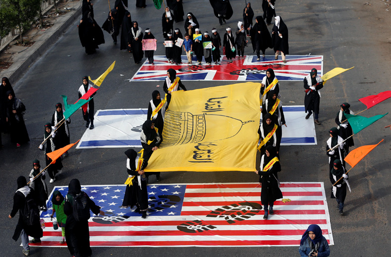 Shi'ite Muslim supporters of the Imamia Student Organization (ISO) hold a flag depicting Dome of the Rock, as they walk over the flags of Britain, Israel and U.S., in a rally marking the annual al-Quds Day, or Jerusalem Day during the Muslim holy month of Ramadan in Karachi, Pakistan June 23, 2017.