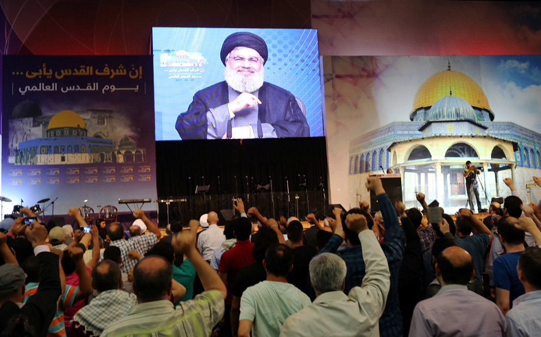 Lebanon's Hezbollah leader Sayyed Hassan Nasrallah addresses his supporters via a screen during a rally marking Al-Quds day in Beirut's southern suburbs, Lebanon June 23, 2017. 