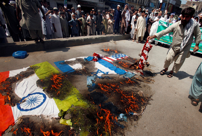 Protesters burn American, Israeli and Indian flags during a demonstration marking the annual al-Quds Day, or Jerusalem Day, during the Muslim holy month of Ramadan in Peshawar, Pakistan June 23, 2017.