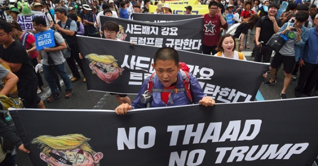 South Korean protestors march toward the US embassy during a rally against the deployment of the U.S. Terminal High Altitude Area Defense (THAAD) system in Seoul on June 24, 2017.