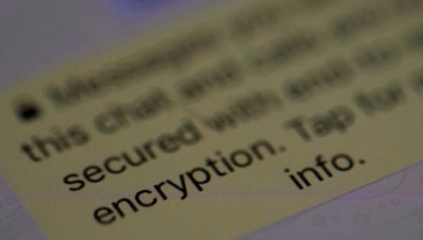 An encryption message is seen on the WhatsApp application on an iPhone in Manchester , Britain March 27, 2017.
