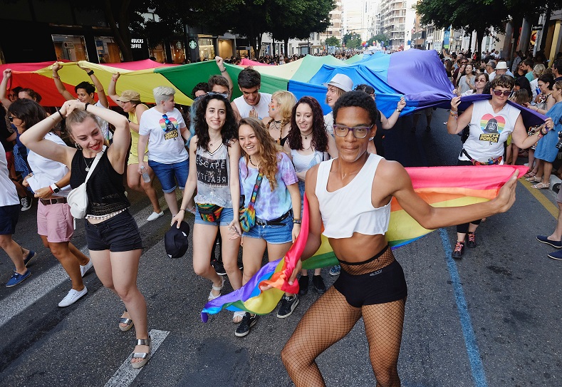 A participant dances next to a giant LGBT flag during the LGBT Pride parade in Valencia, Spain, June 24, 2017.