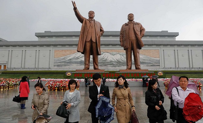 People pass to honor Kim Il Sung, founder of the DPRK worker's state.