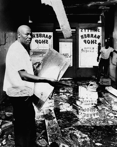 A man tries to pick up the pieces after the riots