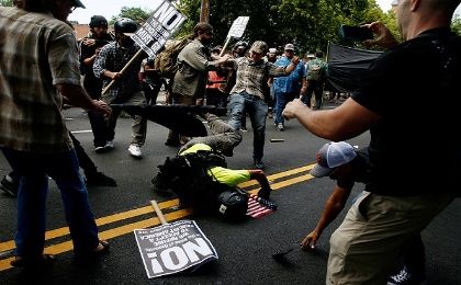 A man hits the pavement during a clash between members of white nationalist protesters and counter-demonstrators in Charlottesville, Virginia, U.S., August 12, 2017. 