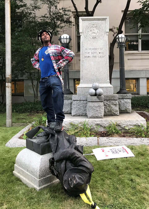 This protester stands proudly on the toppled statue of a Confederate soldier in Durham, North Carolina.