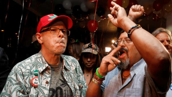 William Britt (L) and Al Moreno (R) celebrate after Californians voted to pass Prop 64, legalizing recreational use of marijuana in the state in California.