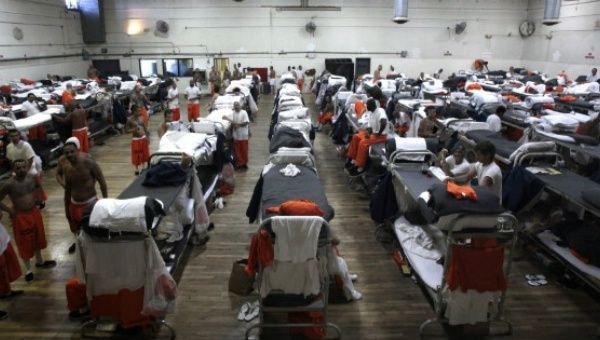 Inmates are housed in a gymnasium due to overcrowding at Chino State Prison in California.