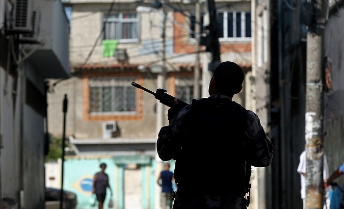A police officer stands guard during a raid on the City of God favela, Rio de Janeiro, Brazil, November 20, 2016