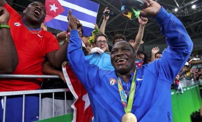 Men's Greco-Roman 130 kg winner Mijain Lopez of Cuba poses with his medal in Rio de Janeiro, Brazil.