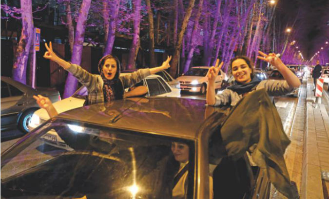 Women in Tehran celebrate after the announcement of an agreement on Iran nuclear negotiations.
