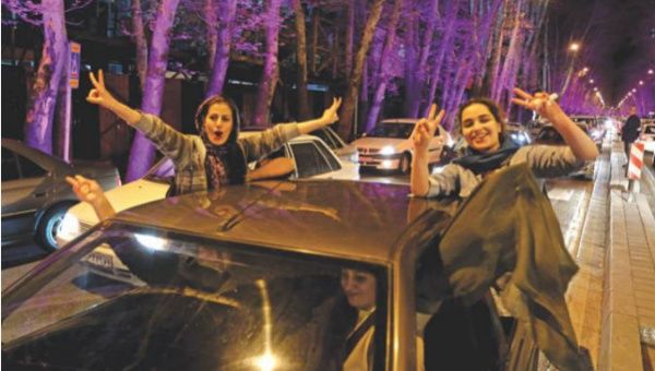 Women in Tehran celebrate after the announcement of an agreement on Iran nuclear negotiations.