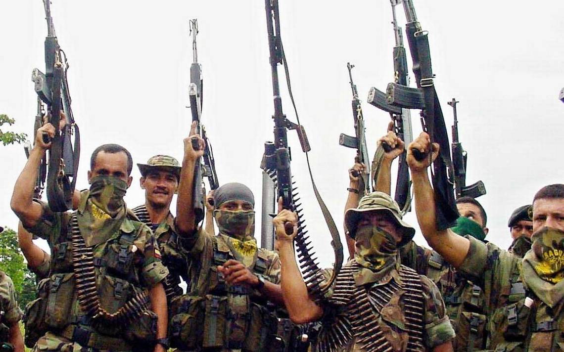 Members of the AUC paramilitary group raise their weapons in this photo dated to 2001.