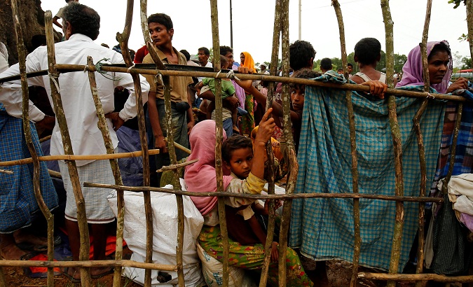 New Rohingya refugees wait to enter the Kutupalang makeshift refugee camp, in Cox’s Bazar, Bangladesh, Aug. 30, 2017.