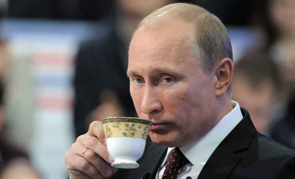 Russian President Vladimir Putin sips a hot cup of tea. (FILE)
