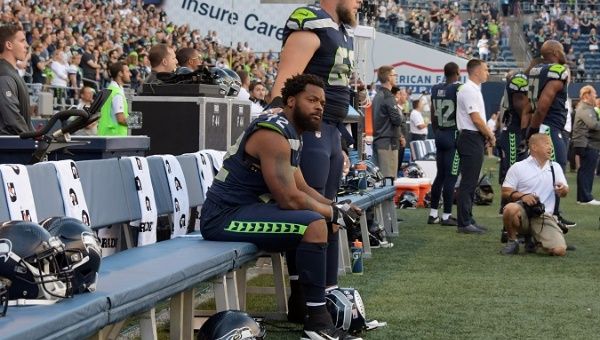 Seattle Seahawks' defensive end Michael Bennett sits out the national anthem on Aug 25, 2017. 