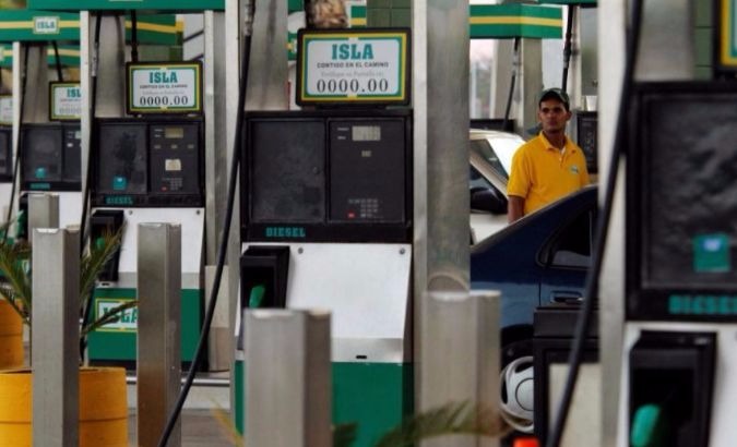 A gas station worker puts fuel in a car in Santo Domingo, Dominican Republic.