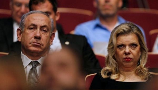 Israeli Prime Minister Benjamin Netanyahu (R) with his wife Sara Netanyahu (L) are both in legal heat for alleged fraud.