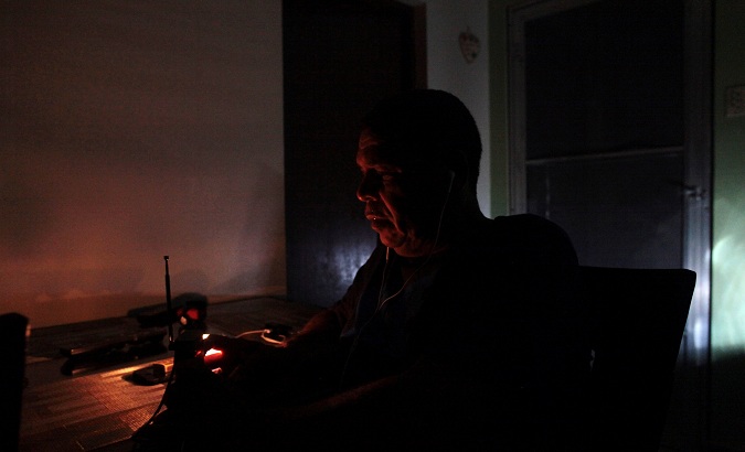 Juan Rivera sits at his home during a blackout after Hurricane Irma in San Juan, Puerto Rico, on September 7, 2017.