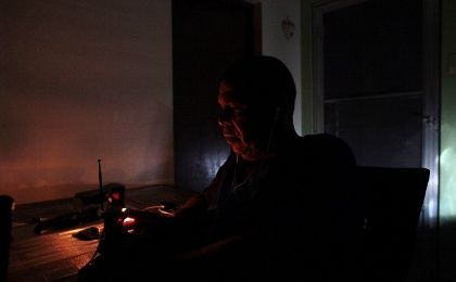 Juan Rivera sits at his home during a blackout after Hurricane Irma in San Juan, Puerto Rico, on September 7, 2017.